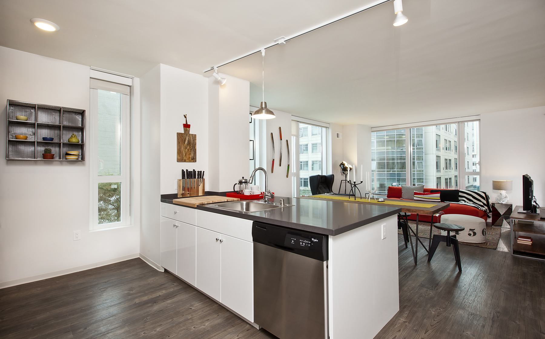Kitchen with white cabinetry, stainless steel appliances, chrome countertops and hard surface flooring
