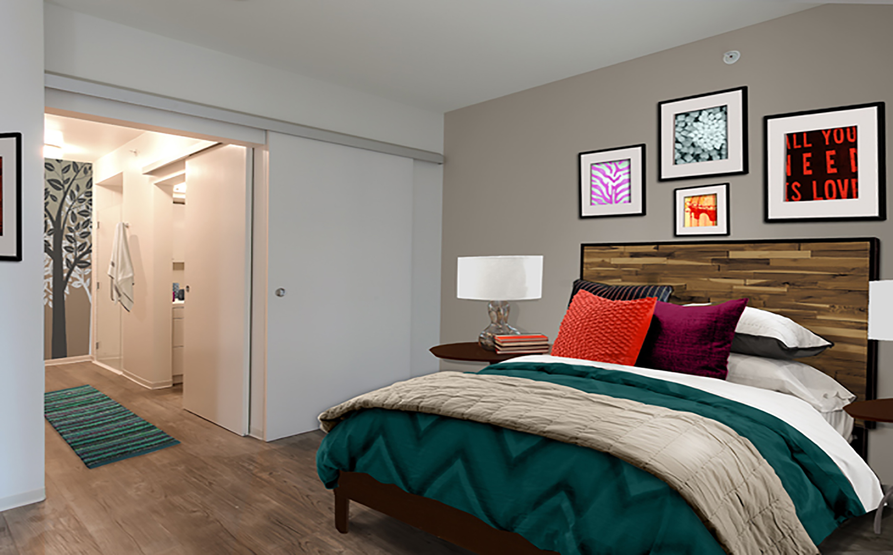 Bedroom with hard surface flooring and sliding barn door