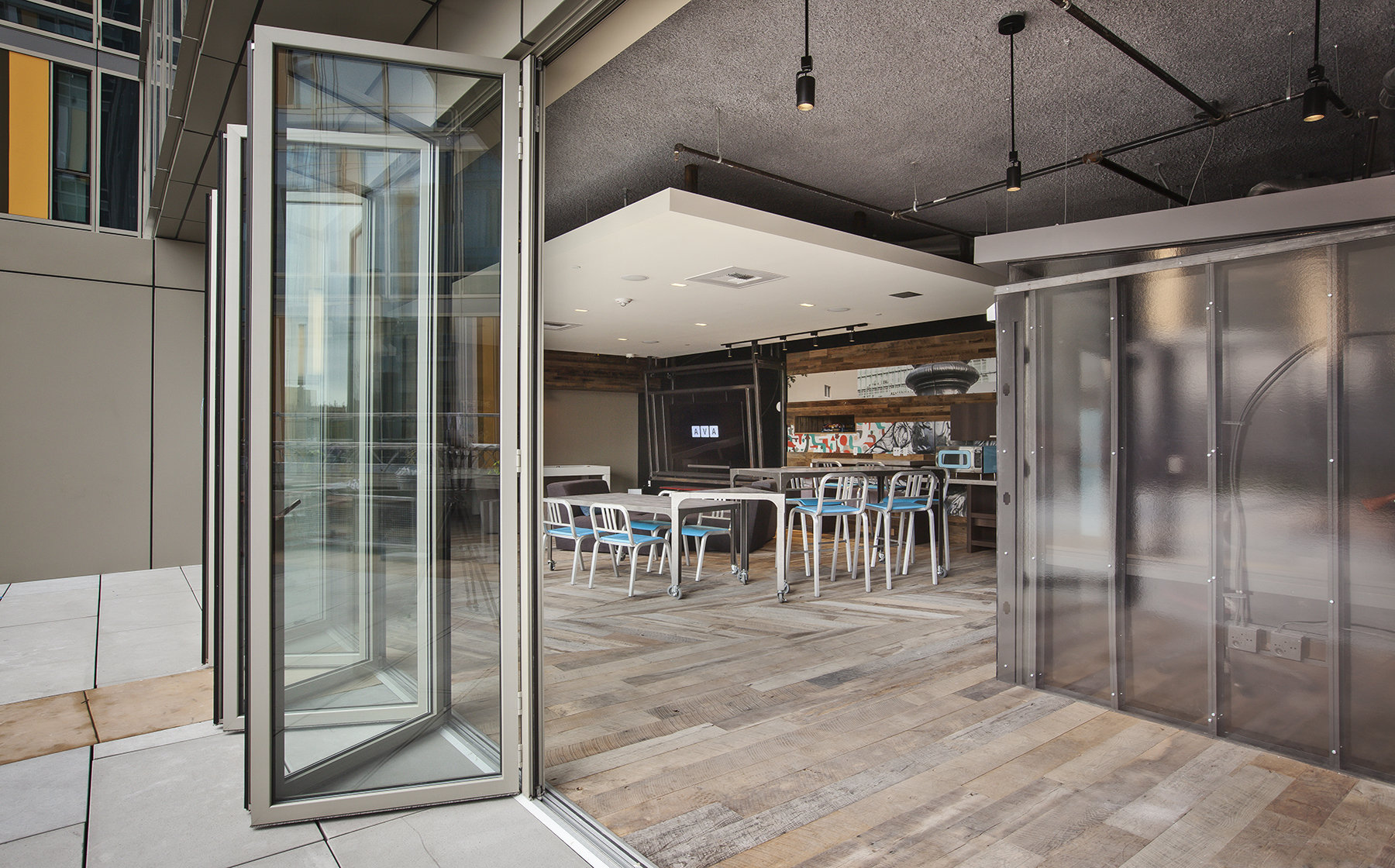 Chill lounge with workstations, common area seating and patio access 