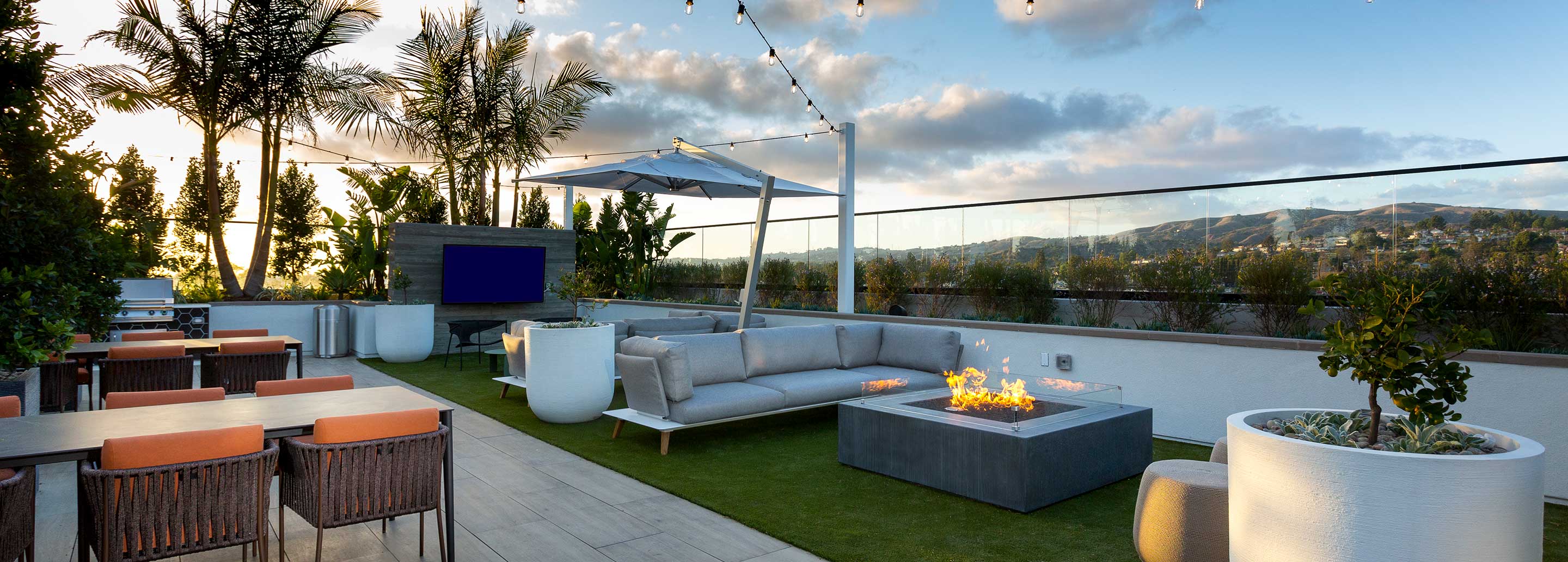 Avalon Brea Place Building B rooftop lounge with fireplace and lounge seating