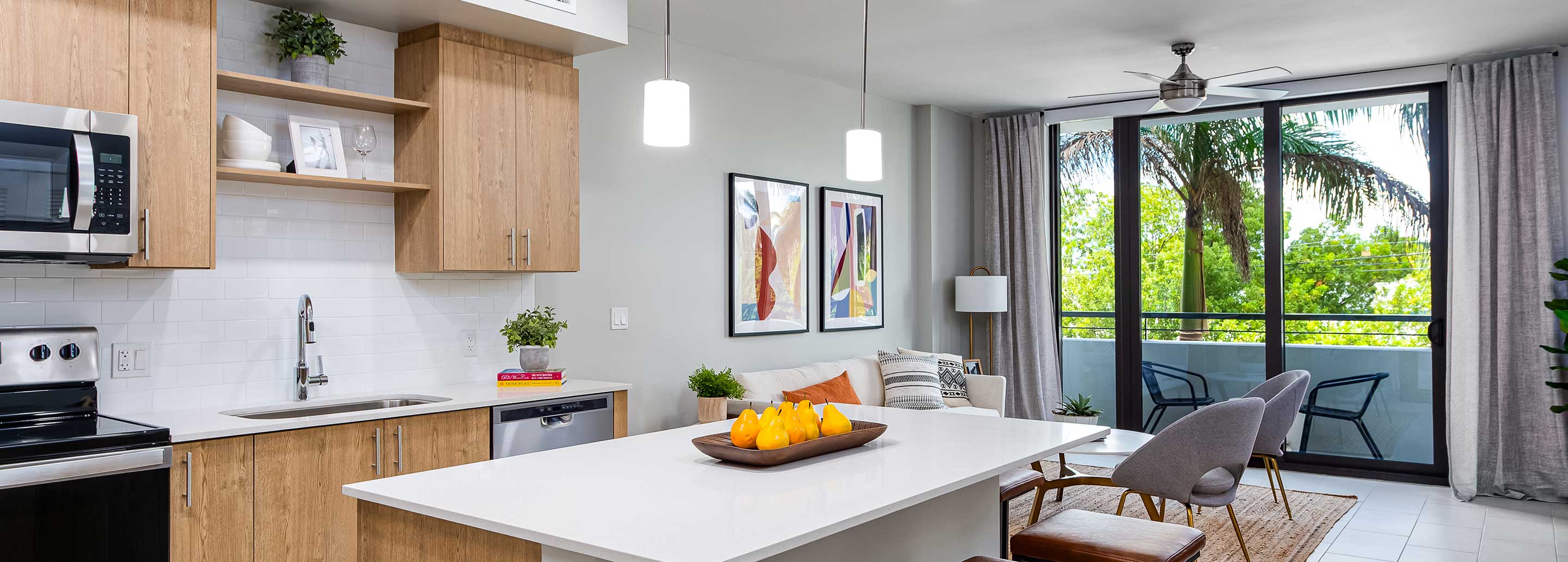 Open concept kitchen with quartz countertop, island, stainless steel appliances and tile backsplash